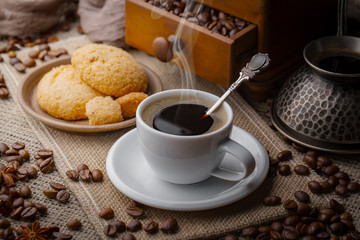 Coffee in a cup and saucer on an old background.