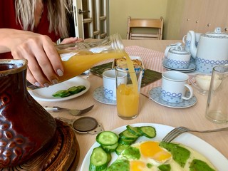 woman pours juice in a glass