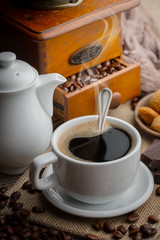 Coffee in a cup and saucer on an old background.