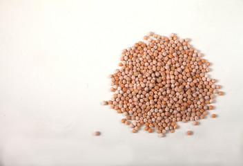 dried yellow raw peas scattered on a white background. Copy spaes. Horizontally