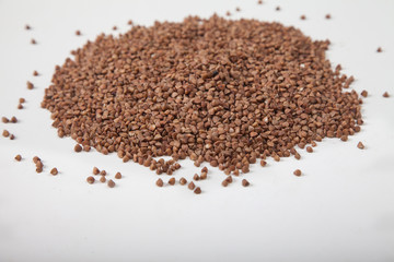 Buckwheat seeds closeup isolated on white background. Top view.