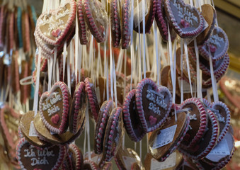 Gingerbread Hearts at German Christmas Market. On traditional ginger bread cookies written "I love you" in German. - Powered by Adobe