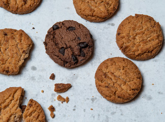 Top view tasty chocolate chip cookies and crunchy malt cookies on white background.