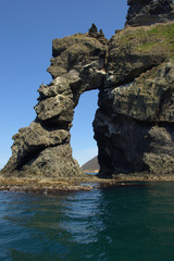 natural rock archway in the sea on a clear sunny day