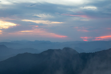 Sunset or evening time over clouds with mountain hill forest and sunlight sunrays or sunbeams on background. at 