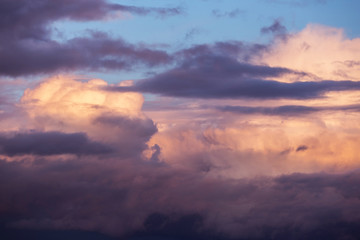 Dramatic sunrise, sunset pink violet sky with clouds background texture