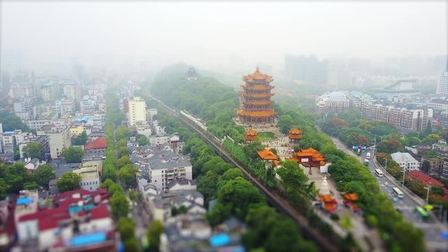 day time wuhan city slum living block yellow crane tample aerial panorama 4k tilt shift china