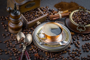 Coffee in a cup and saucer on an old background.