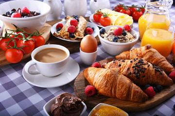 Breakfast served with coffee, juice, croissants and fruits