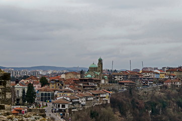 Panorama of a part of residential neighborhood  in background the fortress of Tsarevets, medieval stronghold located on a hill with the same name in Veliko Tarnovo, Bulgaria, Europe  