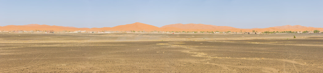 Panorama of the sand dunes of Erg Chebbi with Merzuga in the foreground