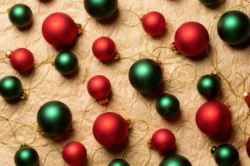 Group of big and small shiny Christmas balls of red and green colors on craft paper background 