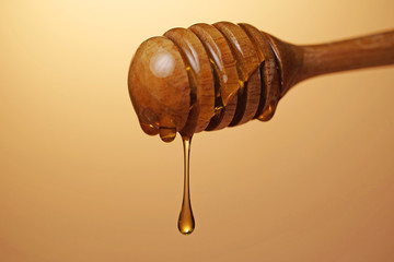 honey dripping on gold color background
