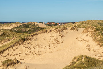 Fototapeta na wymiar Les dunes de la Slack, l'église et le village d'Ambleteuse