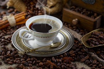 Coffee in a cup and saucer on an old background.