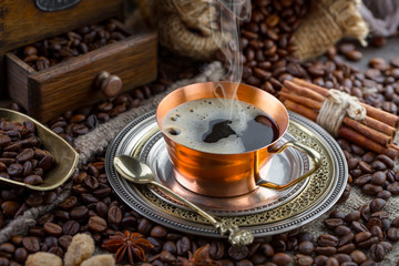 Coffee in a cup and saucer on an old background.
