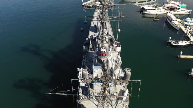 Drone footage of Bremerton, Washington with the downtown marina, the USS Turner Joy naval destroyer ship, sailboats, yachts and fishing boats in the background