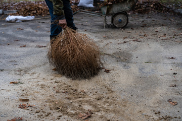 Janitor sweeping a broom yard