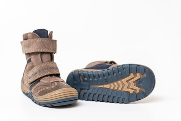 Brown leather stylish children's shoes, boots isolated on white background, close-up.