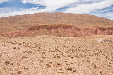 Eroded red cuestas with deep crevasses near the Dades Gorges