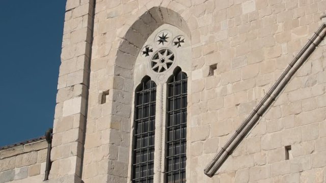 detail of cathedral of venzone, tilt shot of building wall (monument rebuilt after a terrible earthquake)
