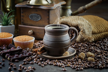 Coffee in a cup and saucer on an old background.