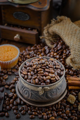 Coffee in a cup on a background of coffee beans, on an old background.