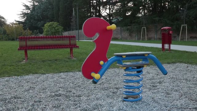 lonely toy at the park, panning shot of a colorful game 