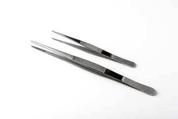 Set of two stainless steel tweezers on white background