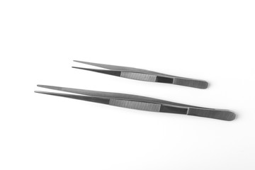 Set of two stainless steel tweezers on white background
