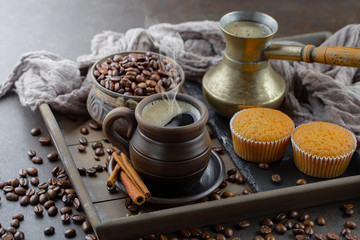 Black coffee beans roast in a pan in the smoke