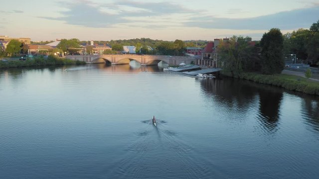 Aerial: People rowing on the Charles River at Harvard University. Boston, Massachusetts, USA. 28 August 2019