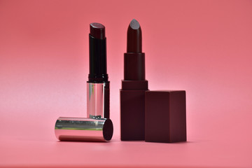 two lipstick on pink background