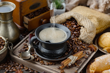 Coffee in a cup and saucer on an old background.