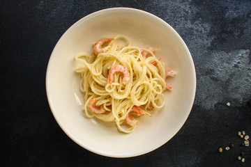pasta shrimp (spaghetti cream sauce and seafood prawn) menu concept. food background. top view. copy space