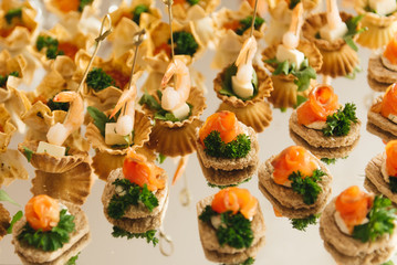 the buffet at the reception. Assortment of canapes. Banquet service. catering food, snacks with cheese, jamon, prosciutto and fruit