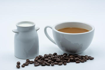Fototapeta na wymiar Milk coffee in a ceramic cup on a white background