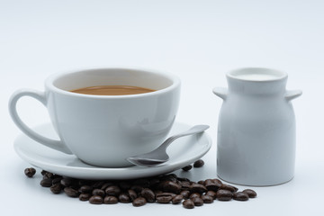 Fototapeta premium Milk coffee in a ceramic cup on a white background