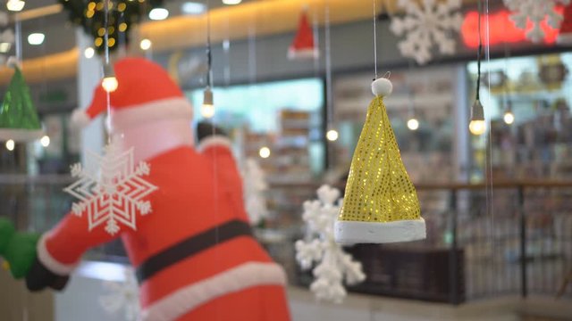 Golden or yellow Santa Claus hat hang or float for Merry Christmas or Xmas and happy new year festival decoration and celebration on winter season 4K