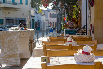 Empty restaurant tables near the road in Cyprus.