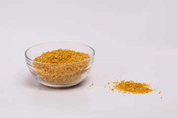 Wheat groats in a plate on a white background. Groats in a small plate. Healthy breakfast on a white background.