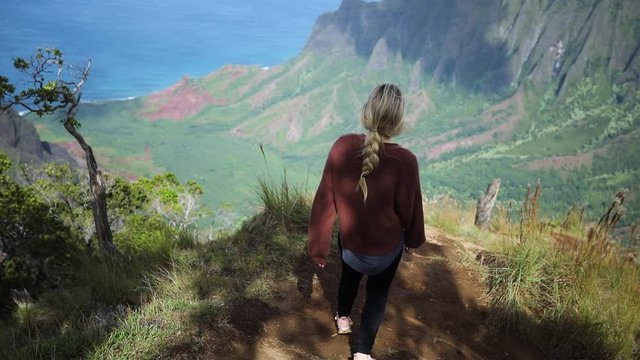 Young Woman Hiking on Trail in Napali Coast State Park in Kauai, Hawaii