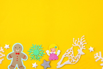 Christmas ornaments on yellow background.