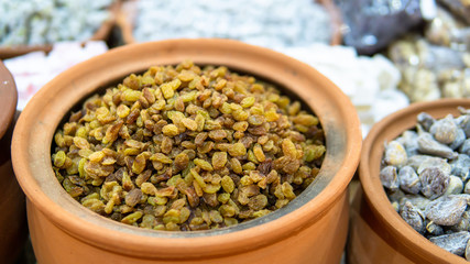 dried grapes in earthenware pots sold in market