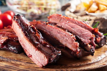 Spicy barbecued pork ribs served with BBQ sauce