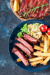 Spicy barbecued pork ribs served with french fries