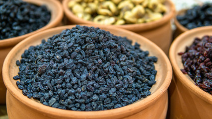 dried grapes in earthenware pots sold in market