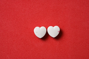 Two heart shaped candies