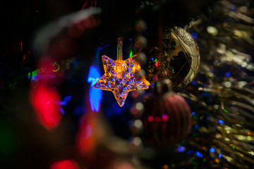 Christmas tree decorated with toys in traditional red and gold color, luminous Christmas garland