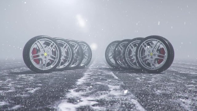 Winter tires on a background of snowstorm, snowfall and slippery winter road. Winter tires concept. Wheel replacement. Road safety concept. 4k 3d animation with falling snow